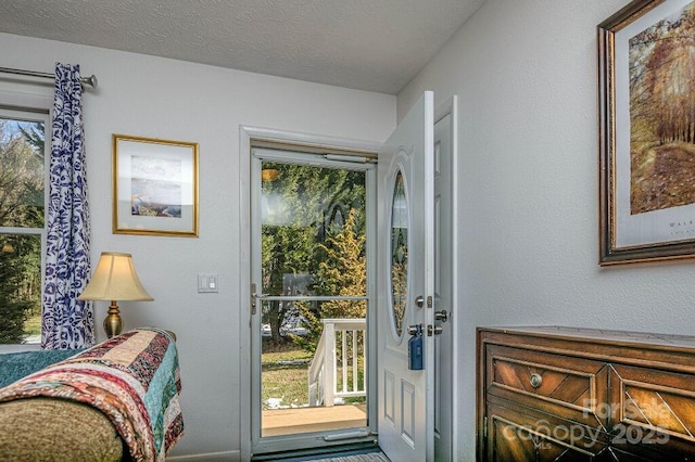 doorway with a textured ceiling