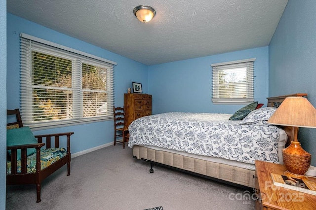 bedroom with carpet floors and a textured ceiling