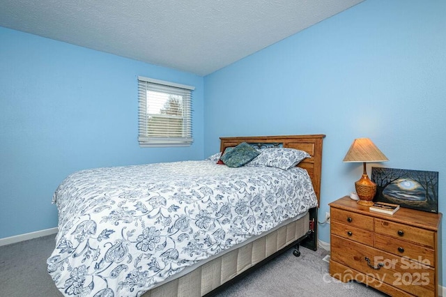 carpeted bedroom with a textured ceiling