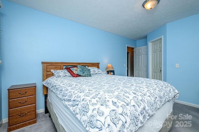 carpeted bedroom with a textured ceiling