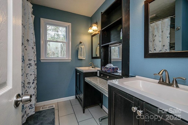 bathroom with vanity and tile patterned flooring