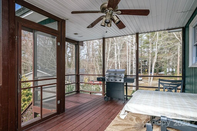 sunroom featuring ceiling fan and wood ceiling