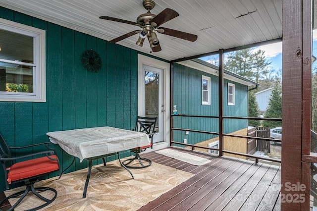 sunroom featuring ceiling fan