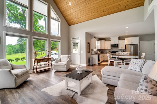 living room with a high ceiling, wooden ceiling, and wood-type flooring