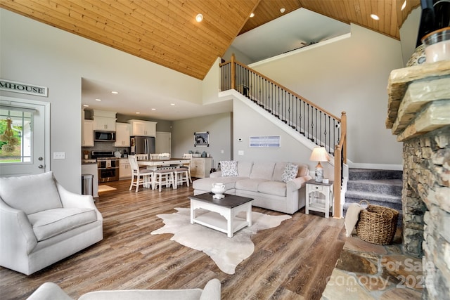 living room with wooden ceiling, hardwood / wood-style floors, and high vaulted ceiling