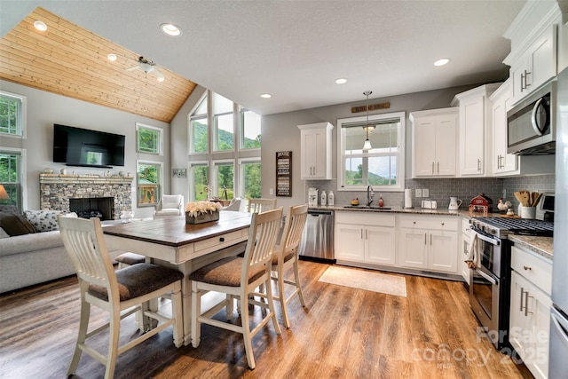 kitchen with pendant lighting, white cabinetry, and stainless steel appliances