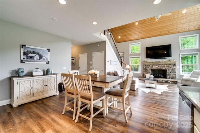 dining area featuring wooden ceiling, a wealth of natural light, hardwood / wood-style floors, and a fireplace