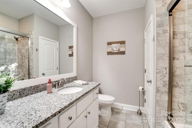 bathroom with an enclosed shower, vanity, toilet, and tile patterned flooring