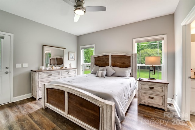 bedroom with dark wood-type flooring, ceiling fan, and multiple windows