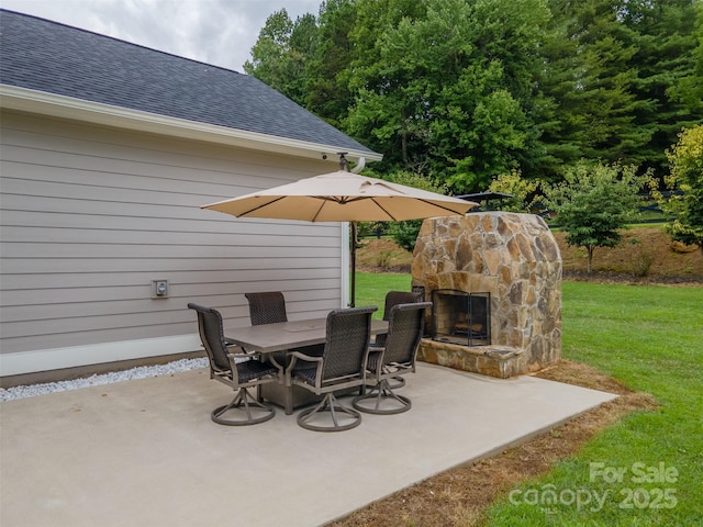 view of patio featuring an outdoor stone fireplace