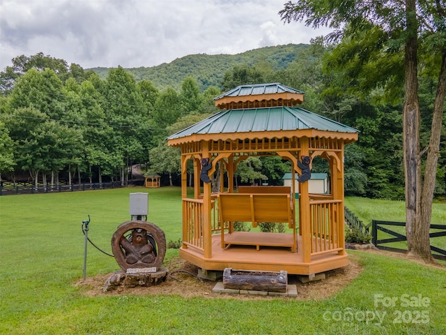 exterior space featuring a gazebo, a mountain view, and a yard