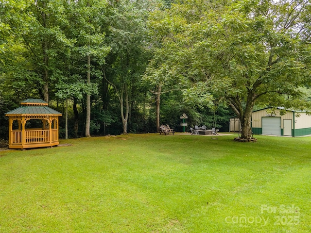 view of yard featuring a gazebo, an outdoor structure, and a garage