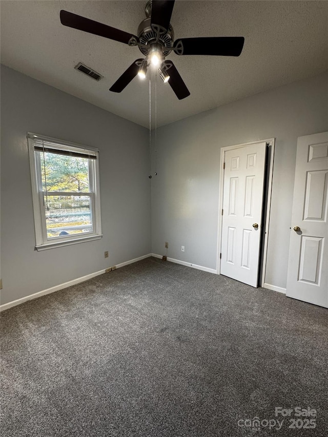 empty room with carpet and ceiling fan