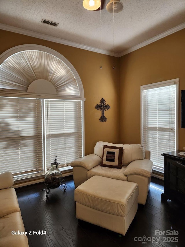 living room with ornamental molding, dark hardwood / wood-style floors, and a textured ceiling