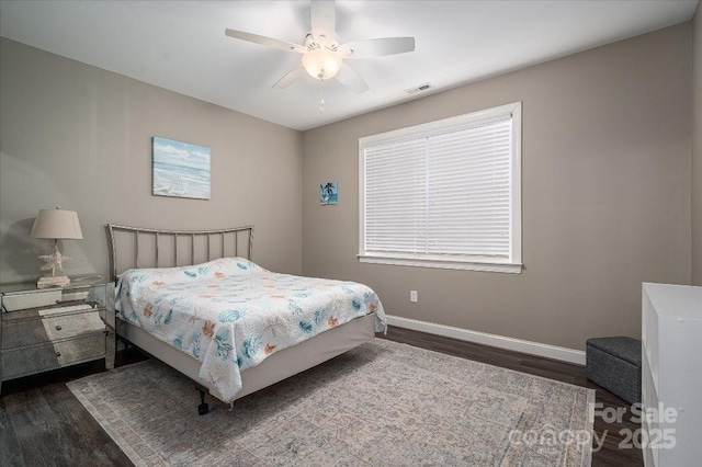 bedroom with ceiling fan and dark wood-type flooring