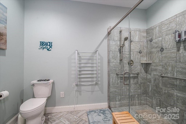 bathroom featuring toilet, walk in shower, and tile patterned flooring