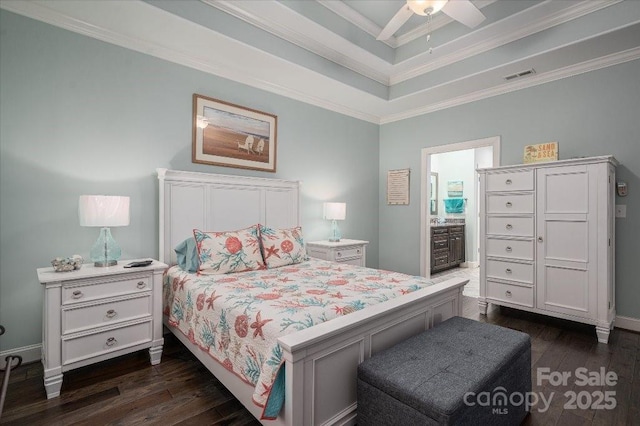 bedroom featuring ceiling fan, ensuite bathroom, dark hardwood / wood-style flooring, and ornamental molding