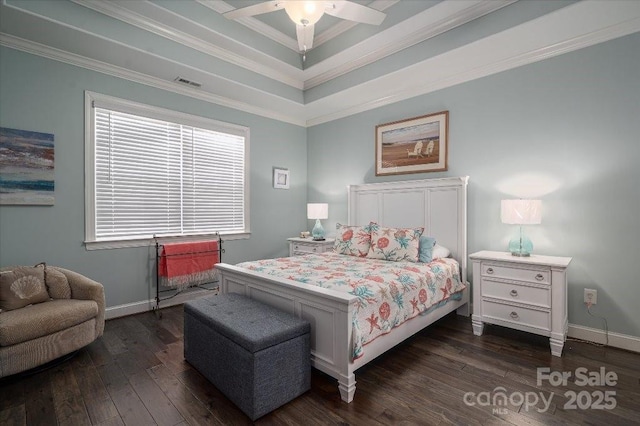 bedroom featuring dark wood-type flooring, a raised ceiling, ceiling fan, and ornamental molding