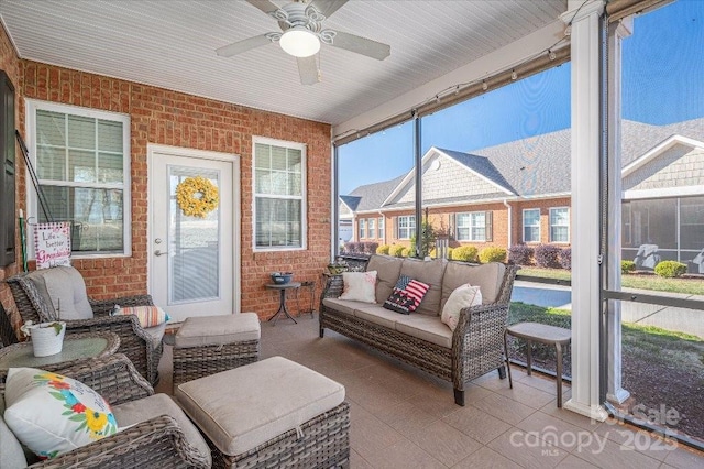 sunroom / solarium featuring ceiling fan