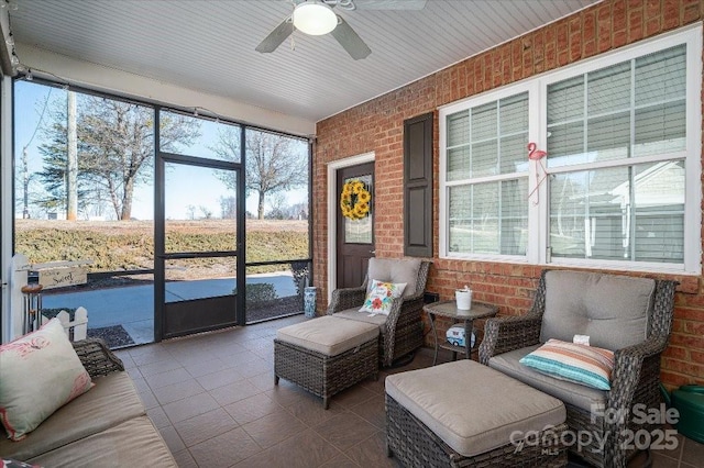 sunroom featuring ceiling fan and a wealth of natural light