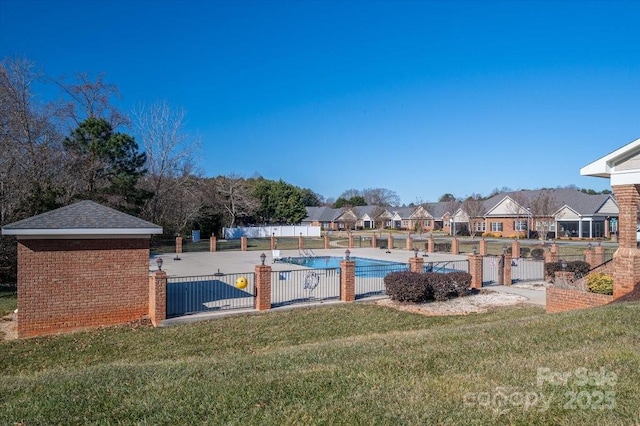 view of pool featuring a lawn