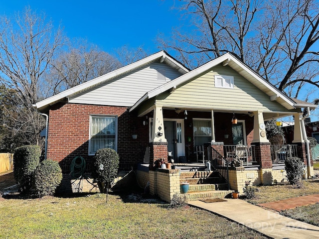 view of front of house with a front lawn and a porch