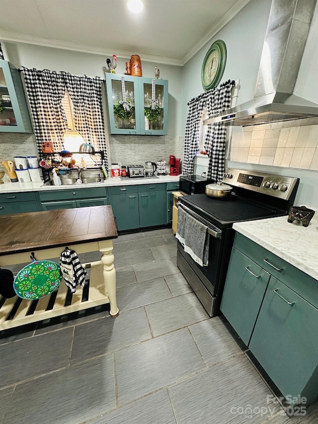 kitchen with crown molding, wall chimney exhaust hood, backsplash, and electric stove