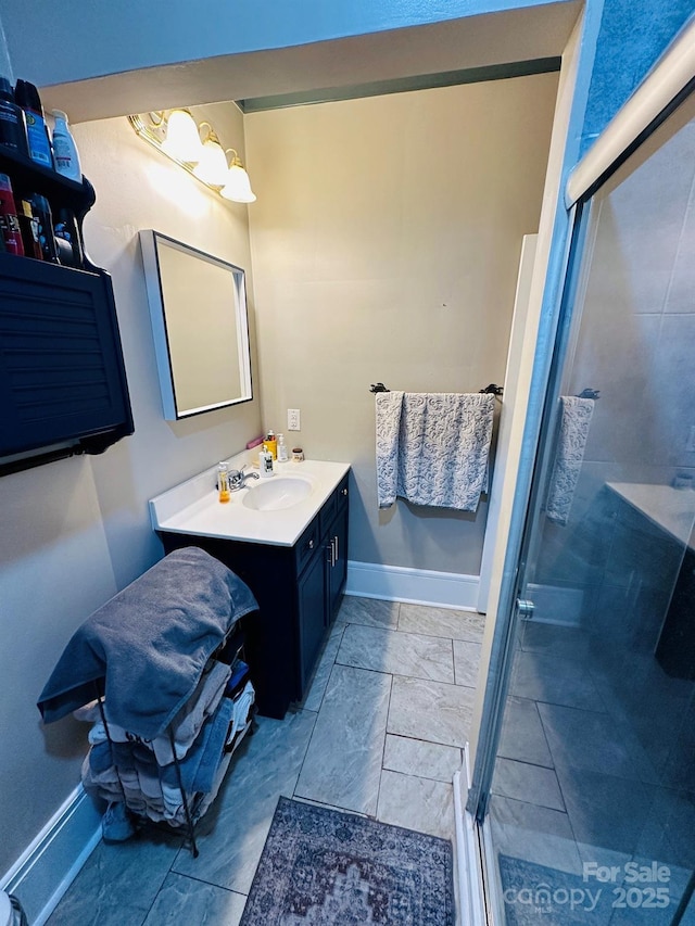 bathroom featuring an enclosed shower and vanity