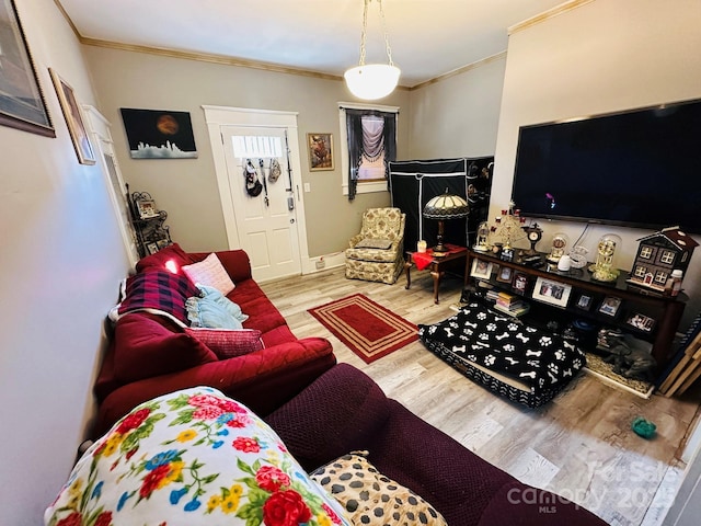 living room featuring wood-type flooring and ornamental molding