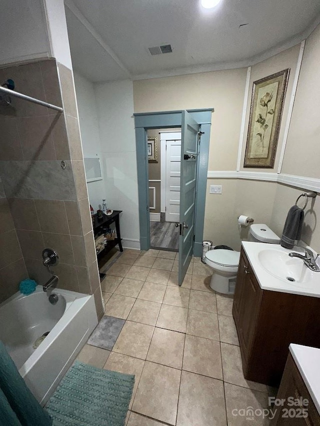 full bathroom with toilet, tile patterned flooring, tiled shower / bath, and vanity