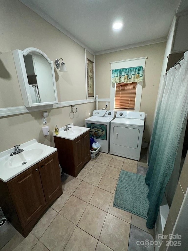 bathroom with vanity, tile patterned flooring, crown molding, and washing machine and clothes dryer