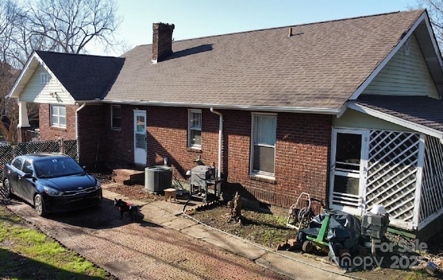 back of house featuring cooling unit