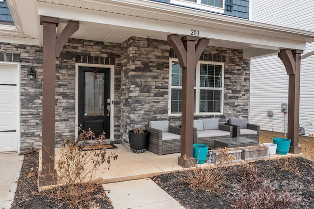 doorway to property with a patio area and an outdoor living space with a fireplace