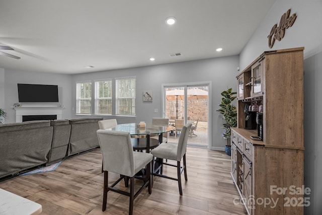 dining area featuring light hardwood / wood-style floors and ceiling fan