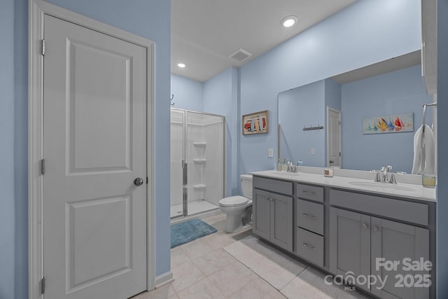 bathroom featuring an enclosed shower, vanity, tile patterned floors, and toilet