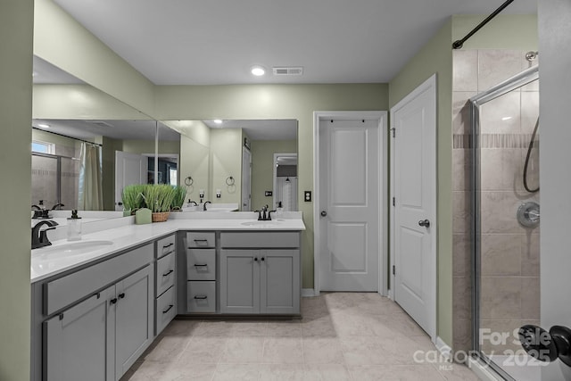 bathroom with vanity, tile patterned flooring, and a shower with shower door