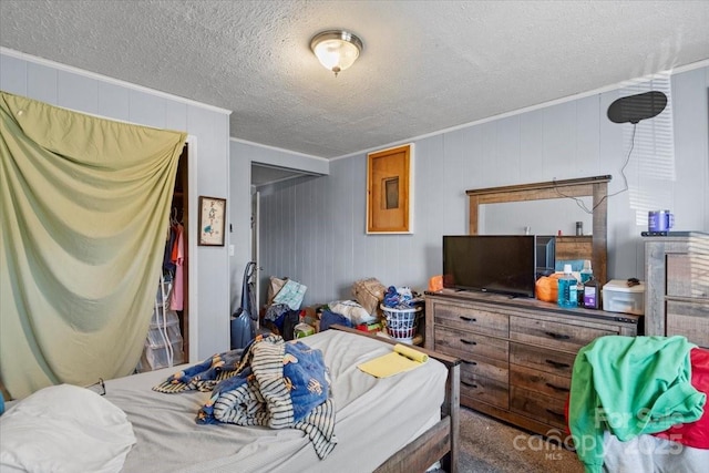 bedroom with crown molding and a textured ceiling