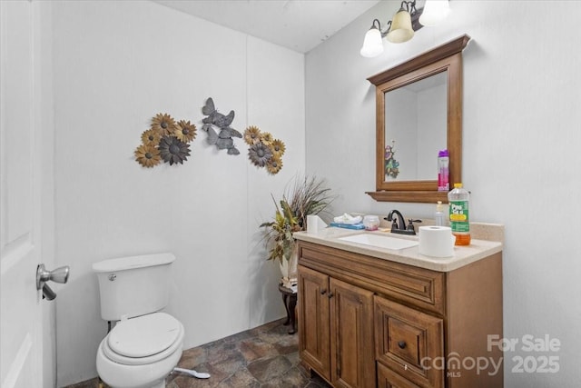 bathroom with toilet and vanity