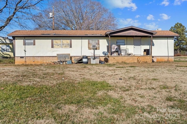 rear view of house with a lawn