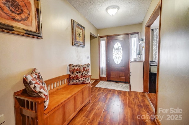 entrance foyer with a textured ceiling and wood finished floors