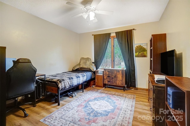 bedroom with light wood-type flooring and a ceiling fan