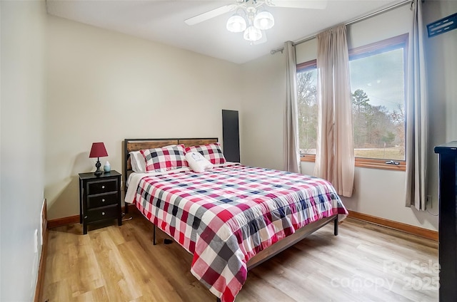 bedroom featuring light wood-type flooring, ceiling fan, and baseboards