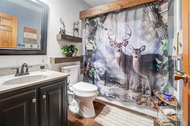 full bathroom with vanity, wood finished floors, and toilet