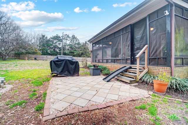 view of patio / terrace with area for grilling, fence private yard, and a sunroom