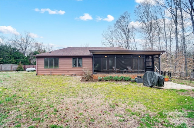 rear view of house featuring a lawn, a sunroom, crawl space, fence, and a patio area