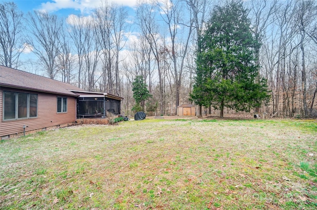 view of yard with an outbuilding, a storage unit, and a sunroom