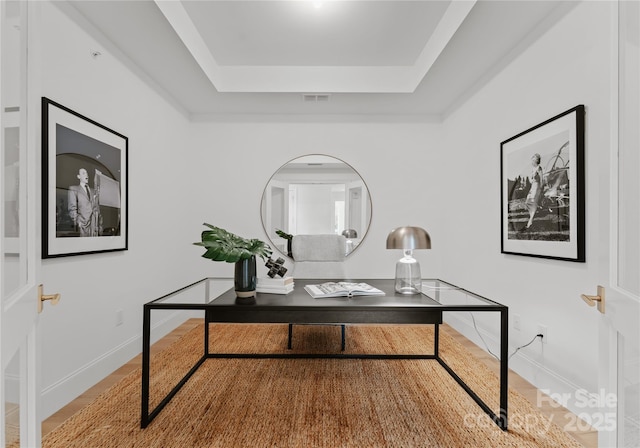 office area with a tray ceiling