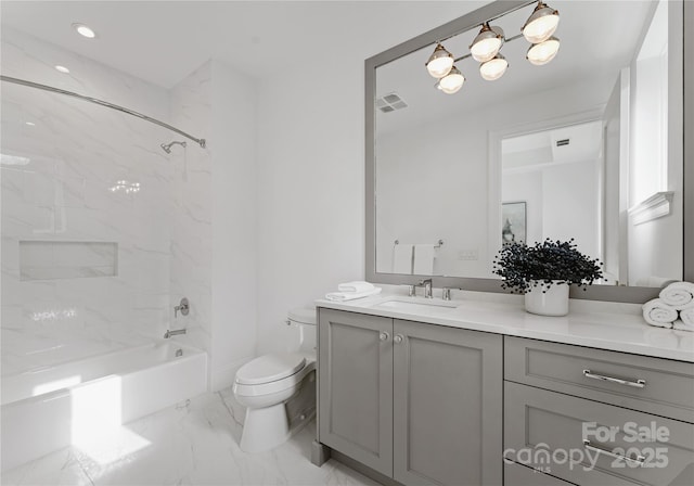 full bathroom with vanity, toilet, and tiled shower / bath