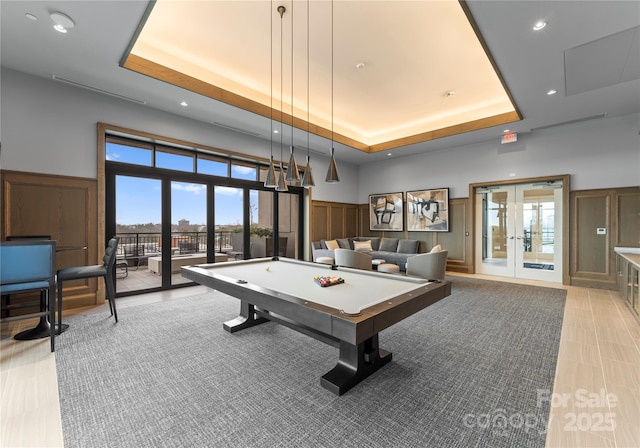 rec room with french doors, pool table, a healthy amount of sunlight, and a tray ceiling