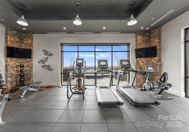 workout area featuring a raised ceiling